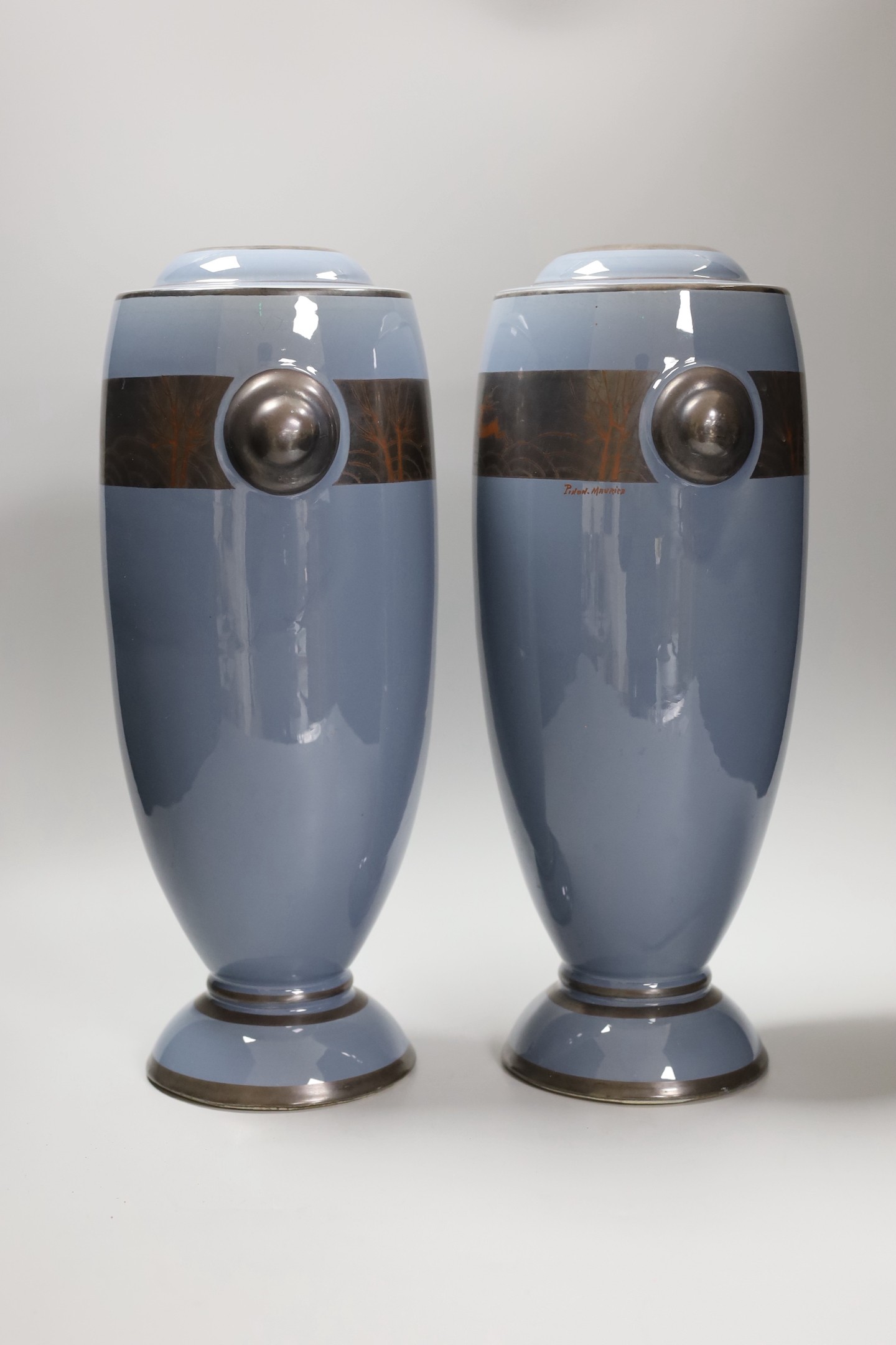 A pair of Art Deco vases signed Pinon Maurice with a pewter lustre stand. 36cm high